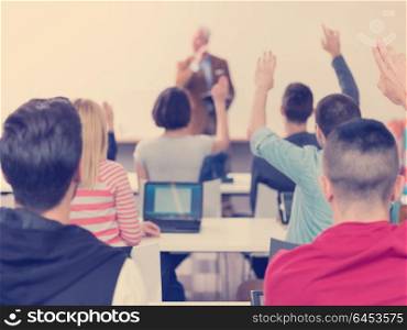 senior teacher teaching lessons, smart students group raise hands up in school classroom on class