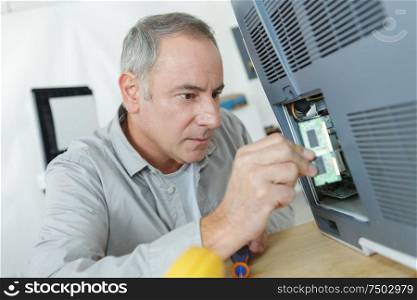 senior technicianworking on electric appliance