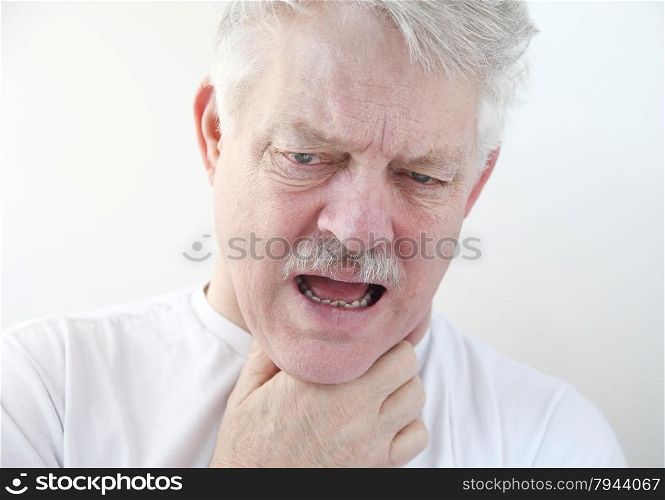 senior with a hand on his painful throat