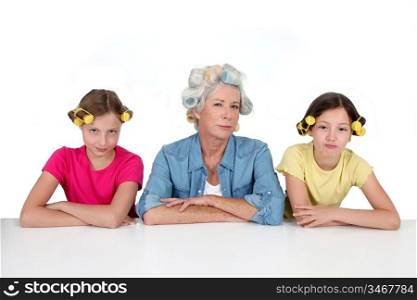Senior woman and kids with hair curlers