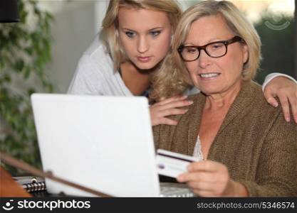 Senior woman and young girl in front of a laptop