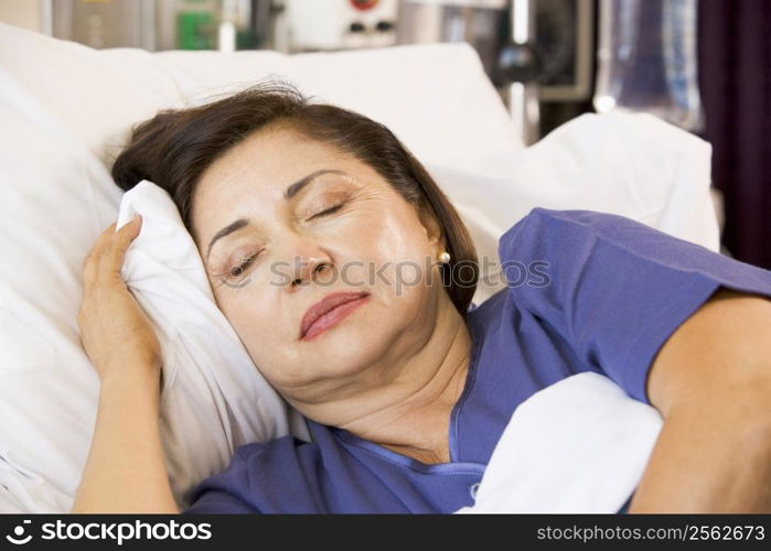 Senior Woman Asleep In Hospital Bed