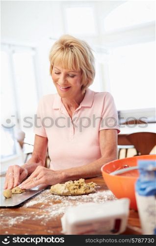 Senior Woman Baking Cookies In Kitchen