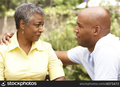Senior Woman Being Consoled By Adult Son