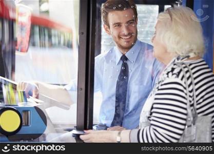 Senior Woman Boarding Bus And Buying Ticket