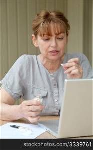 Senior woman checking medical information on internet