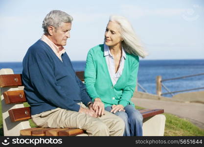 Senior Woman Comforting Depressed Husband Sitting On Bench