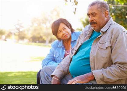 Senior Woman Comforting Unhappy Senior Husband Outdoors