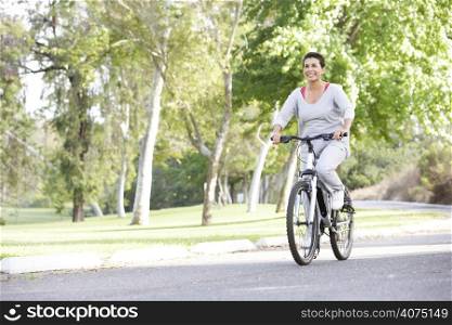 Senior Woman Cycling In Park