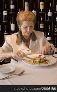 Senior woman dining in restaurant