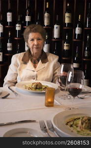 Senior woman dining in restaurant