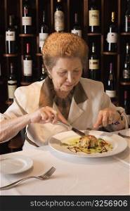 Senior woman dining in restaurant