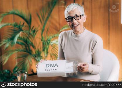 Senior Woman Doing a Mailed DNA Test at Home