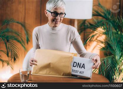 Senior Woman Doing a Mailed DNA Test at Home