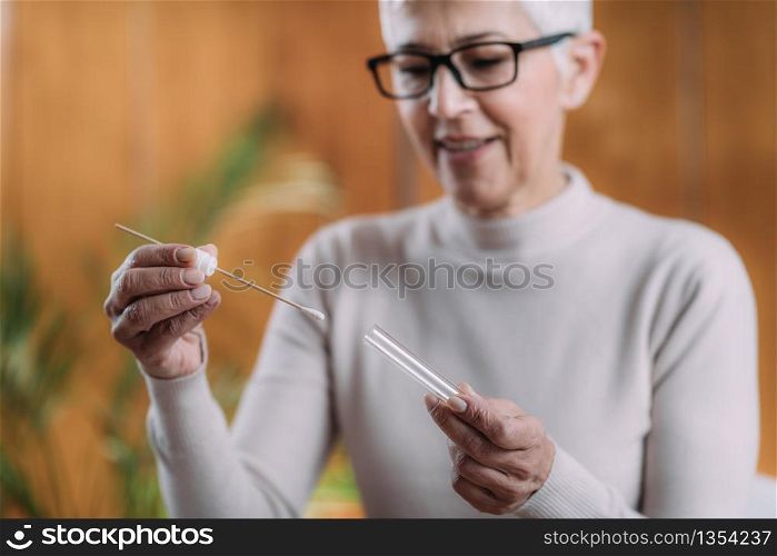 Senior Woman Doing DNA Test at Home.