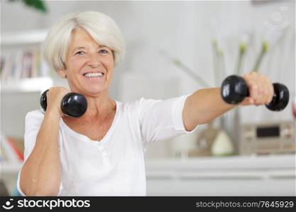 senior woman doing fitness sport in gym