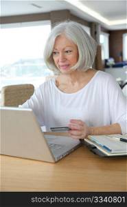 Senior woman doing online shopping at home