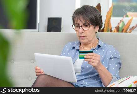 Senior woman doing online shopping at home