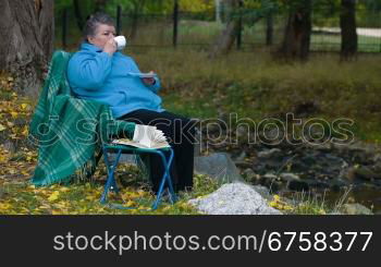 senior woman drinking coffee, Side View