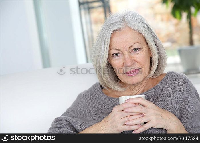Senior woman drinking hot drink