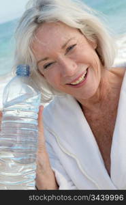 Senior woman drinking water from bottle