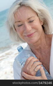 Senior woman drinking water from bottle