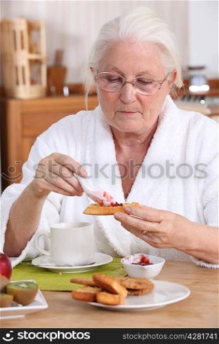 senior woman eating breakfast