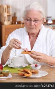 senior woman eating breakfast