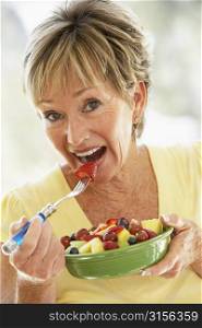 Senior Woman Eating Fresh Fruit Salad