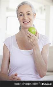 Senior Woman Eating Green Apple