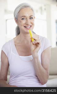 Senior Woman Eating Pineapple