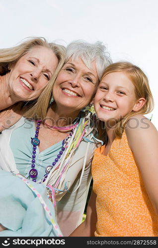 Senior woman embracing daughter and granddaughter