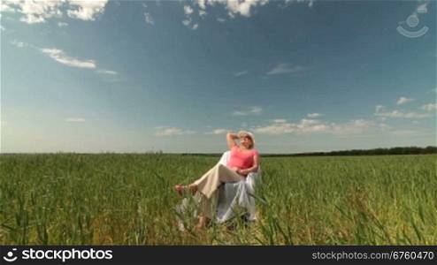 Senior woman enjoying summer holidays on the nature, long shot