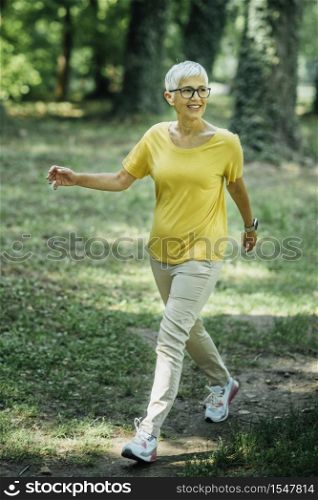 Senior Woman Enjoying Walking Exercise in Nature