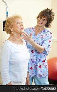Senior woman exercising her neck with help from chiropractic physical therapist.