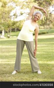 Senior Woman Exercising In Park