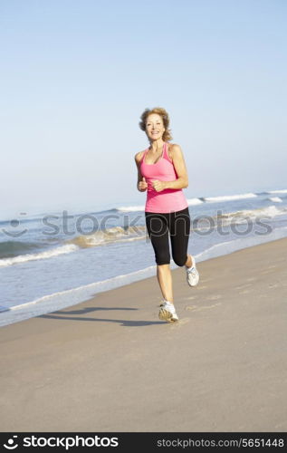 Senior Woman Exercising On Beach