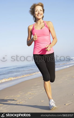 Senior Woman Exercising On Beach
