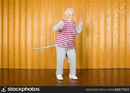 Senior woman exercising with a hula hoop