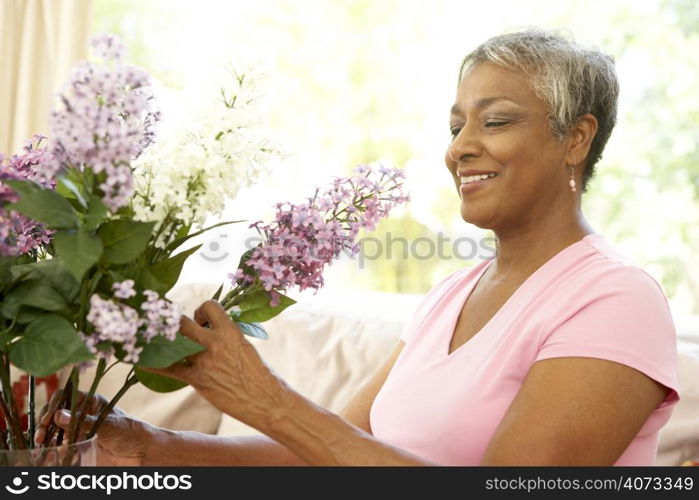 Senior Woman Flower Arranging At Home