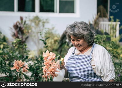 Senior woman gathering flowers in garden