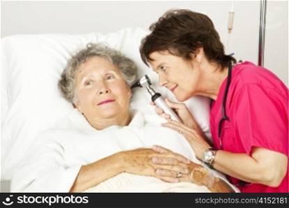 Senior woman gets a medical exam from a nurse in the hospital.