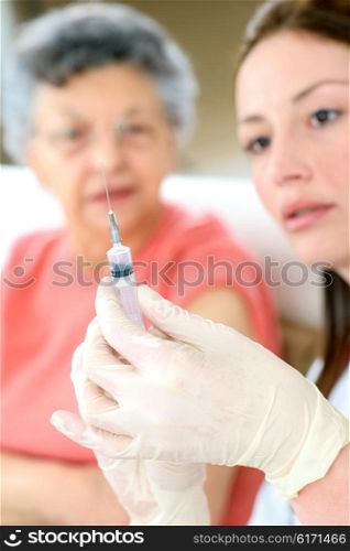 Senior woman getting a flu jab