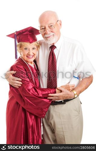 Senior woman graduating from college, standing with her proud, supporting husband. Isolated on white.