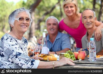 Senior woman having a picnic with friends