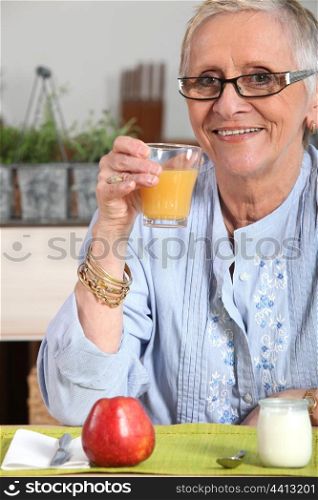 senior woman having breakfast