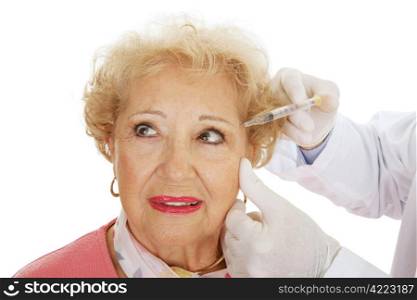Senior woman having cosmetic surgery injections to fill in wrinkles around eyes. White background.