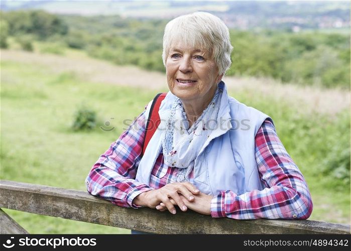 Senior Woman Hiking In Countryside