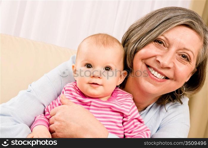 Senior woman hold little baby girl cute smiling close-up