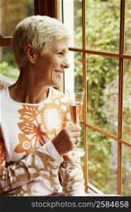 Senior woman holding a champagne flute and smiling